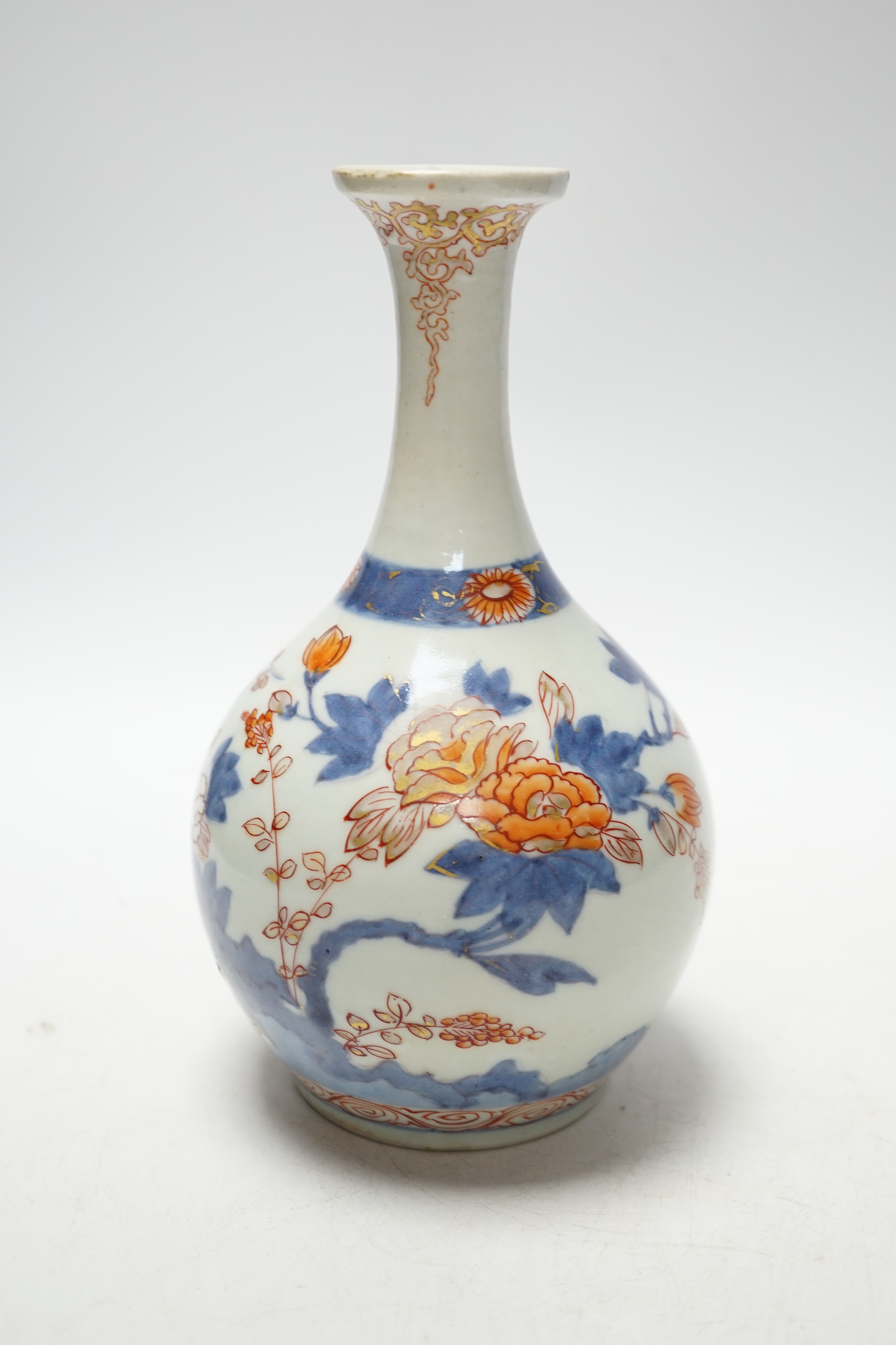 An 18th century Japanese Imari sake flask and a Chinese clobbered blue and white bowl (a.f), tallest 20cm